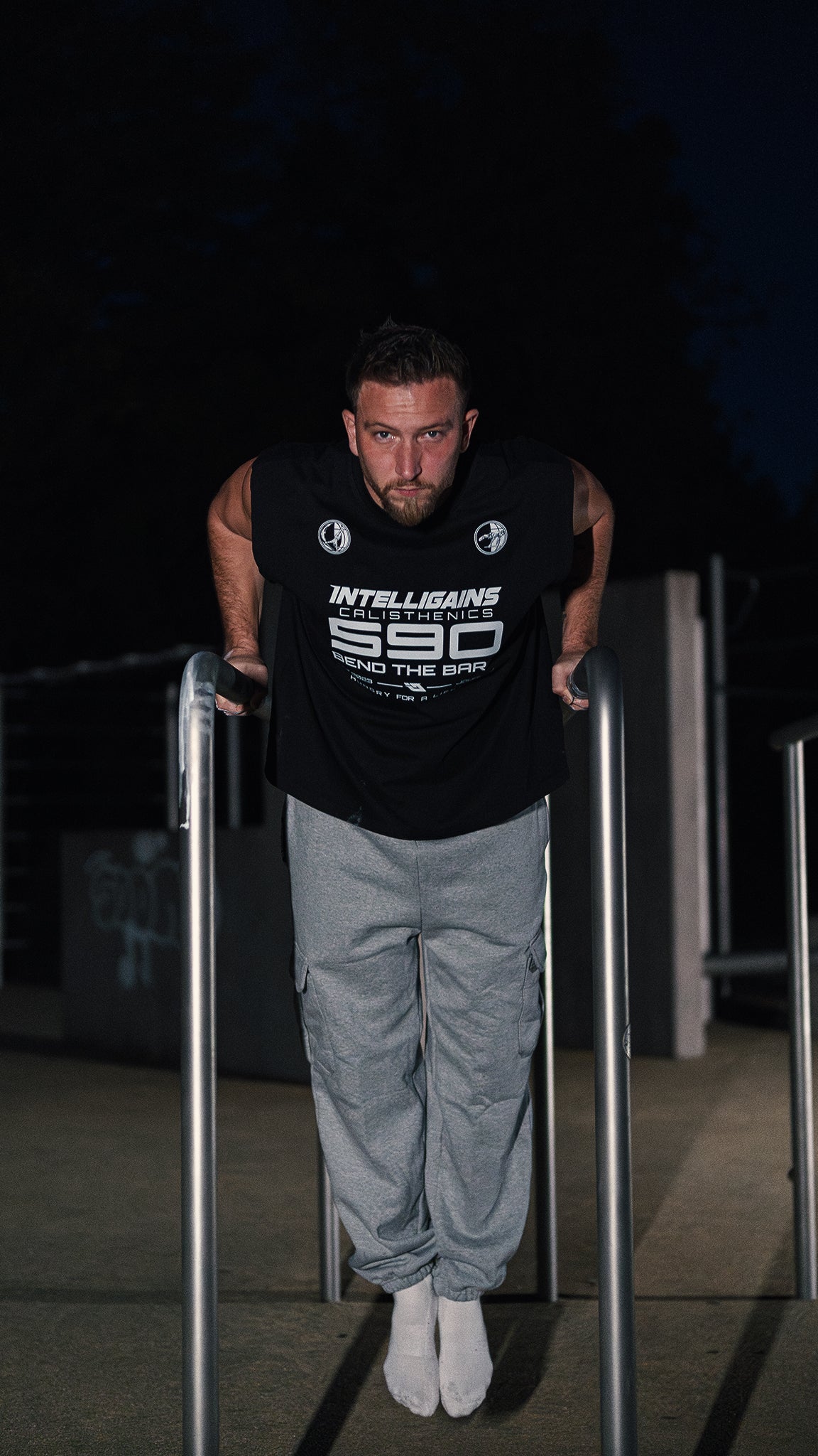 Athlete in the NO EXCUSES Cargo Jogger training on the parallel bars