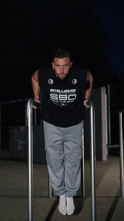 Athlete in the NO EXCUSES Cargo Jogger training on the parallel bars