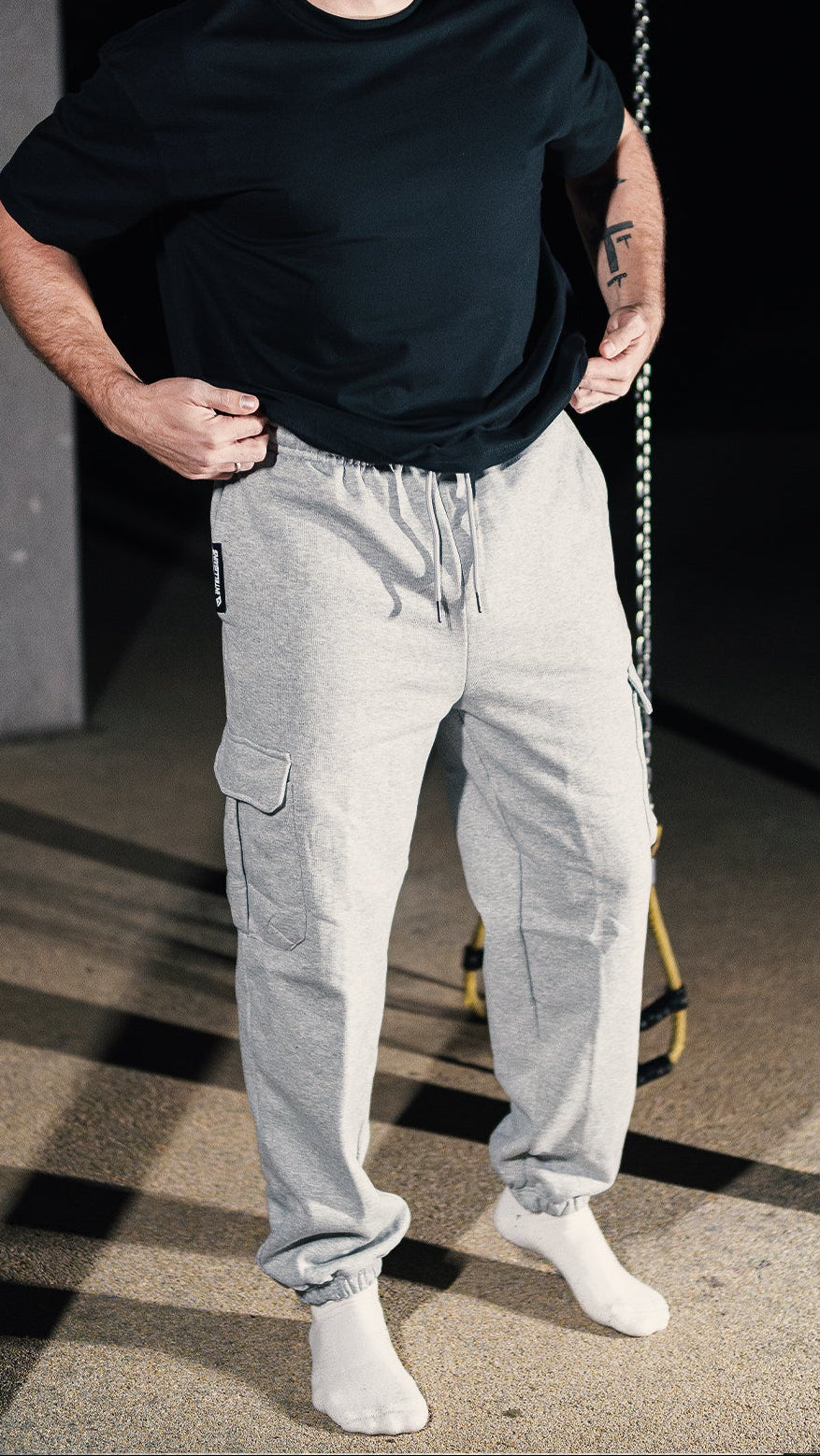 Athlete in the NO EXCUSES Cargo Jogger and a black shirt, full-body view